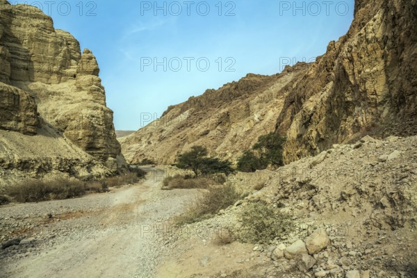 Misty winter day over the Dead Sea. Judean desert. Ancient ruined mountains of solid limestone.