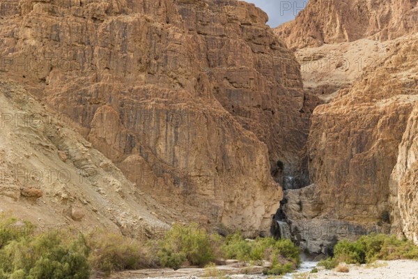 Cascading waterfall in a narrow gorge. The Judean Desert around the Dead Sea after heavy winter