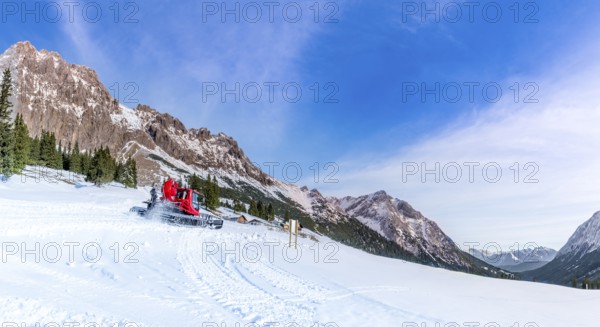 A sunny day of winter on the snowy pastures and the rocky peaks of the Austrian Alps mountains,