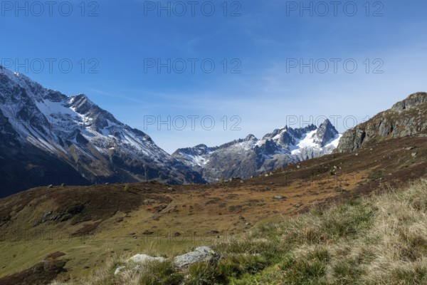 Beautiful autumn landscape in the central Alps, Switzerland. Orange colours and alpine wilderness