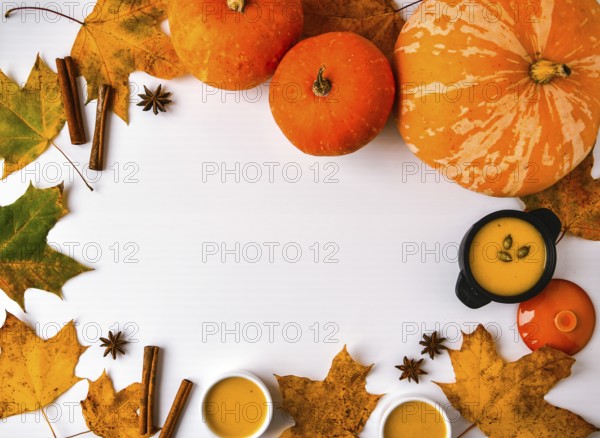 Autumn food. Frame of pumpkin puree soup, leaves. Top view. Autumn harvest, pumpkins, leaves on