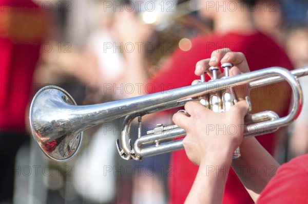 A jazz trumpeter plays of his trumpet in the brass band during a carnival live event. Blurry close