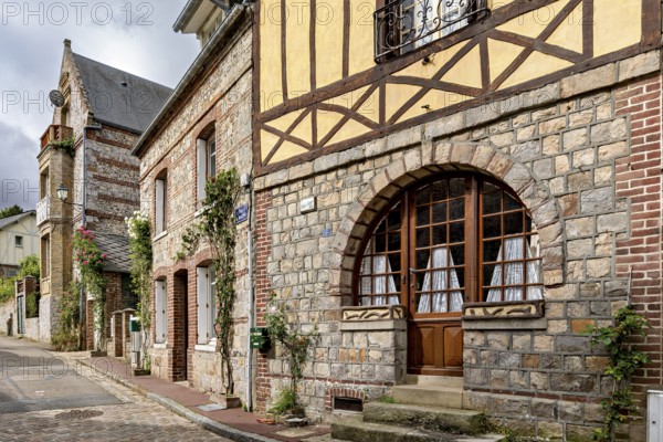 Charming stone and half-timbered houses with large windows in an old street, The historic mill