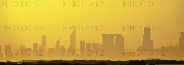 Sandstorm, samum, haboob over the southern megalopolis, the outline of skyscrapers are drowning in