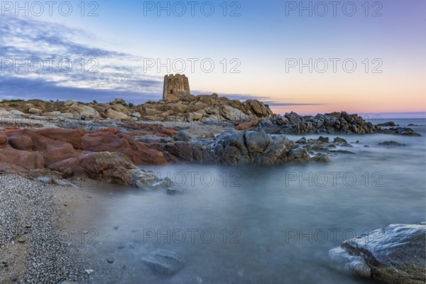 Old historic tower from the 16th century and rocks at sunset on the beach, long exposure, Torre di