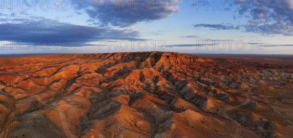 Aerial panorama of textural colorful striped canyons Tsagaan suvarga, White stupa at sunrise.