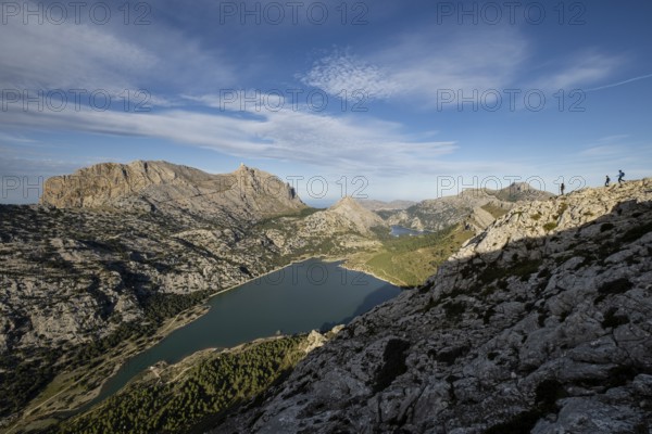 Trekkers on the crest of the Puig de Rateta with the Puig Major in the background, Escorca,