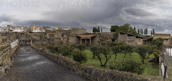 Ercolano, Italy, 25 November, 2023: orchard and street in the excavated ancient Roman city of