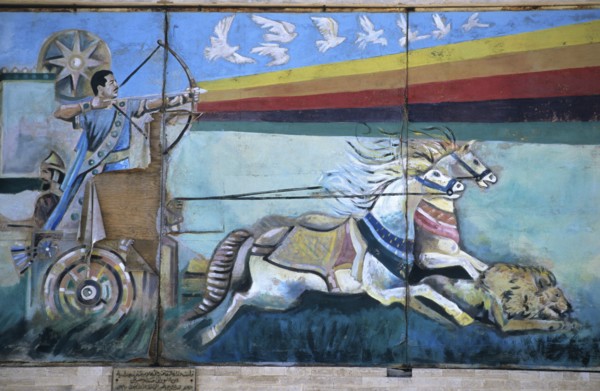 Wall mural depicting Saddam Hussein shooting an arrow from a bow while riding down a lion from a Roman war chariot, painting since destroyed, Mosul, Iraq, Middle East/Darstellung Saddam Husseins als F...