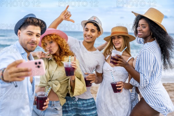 Group of cheerful young multi ethnic friends in summer clothes taking selfie with smartphone and