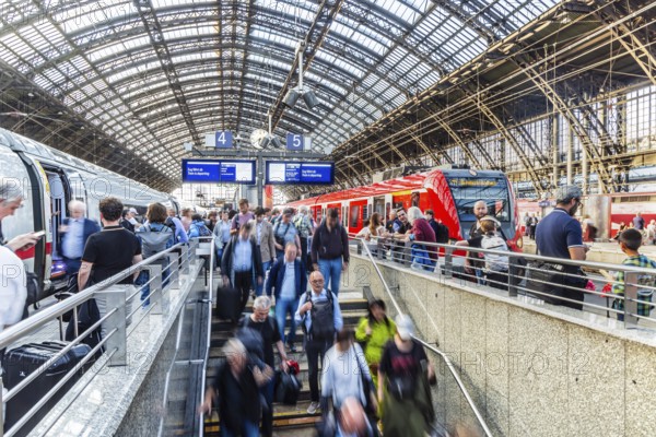 Cologne Central Station. Stairs to the platforms. Travellers waiting for their train on the