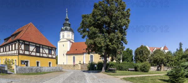 St George's Church and moated castle, Großkmehlen village square, Ortrand, Brandenburg, Germany