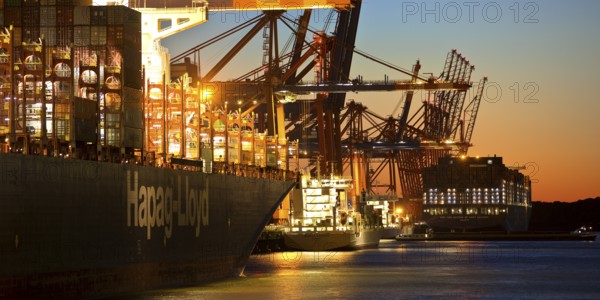 Container ships at the Eurogate container terminal in the evening with an atmospheric sunset,