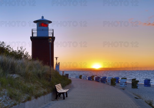 Olhörn lighthouse at colourful sunrise over the sea on the North Frisian island of Föhr,
