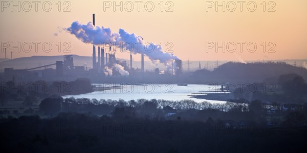 View in front of sunrise from the Rheinpreussen spoil tip onto the Rhine in Duisburg with the