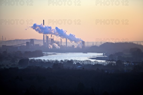View in front of sunrise from the Rheinpreussen spoil tip onto the Rhine in Duisburg with the