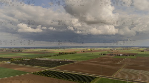 Landscape with wide fields and dramatic clouds in the sky, Straubing, Lower Bavaria, Germany