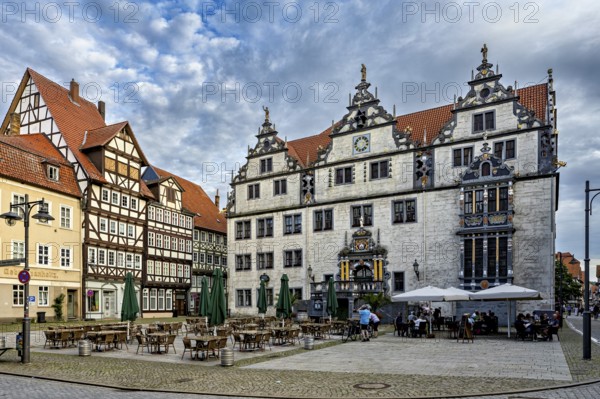 Historic square with half-timbered houses and classic buildings, under a cloudy sky, The historic