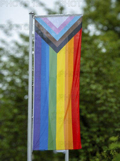 A rainbow flag hangs in front of the building of the Protestant Church of the Palatinate on