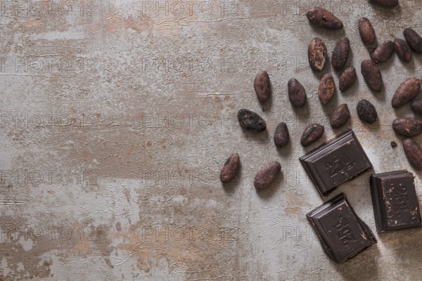 Chocolate pieces with raw cocoa beans rustic background. Resolution and high quality beautiful
