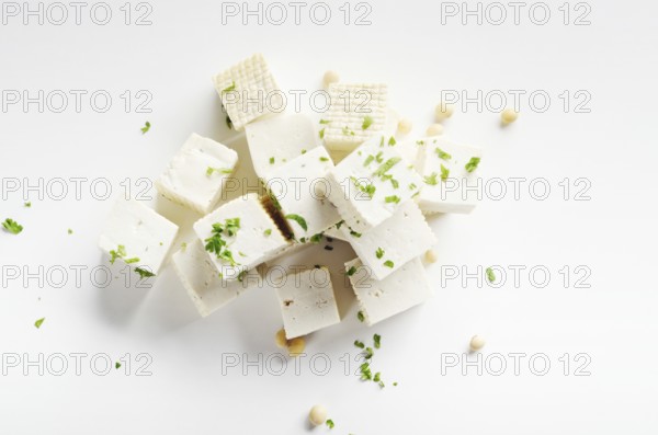 Soy Bean curd tofu with greens on white background Non-dairy alternative substitute for cheese