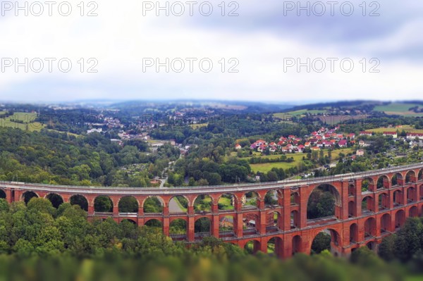Aerial view of the Göltzsch Valley Bridge, an impressive brick viaduct that spans majestically over