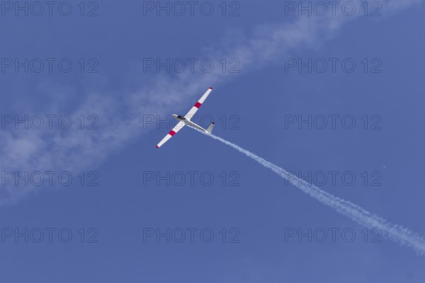 Airshow, glider with contrails against blue sky, Montreal, Province of Quebec, Canada