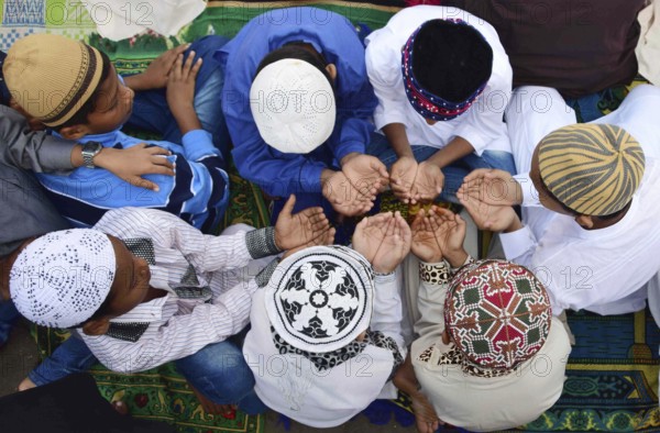 Young Muslim boys offer prayer as they celebrate Eid al-Adha or festival of sacrifice, at the Bilal