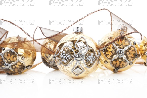 Luxurious antique golden christmas balls decorated with brown ribbon. Traditional festive xmas
