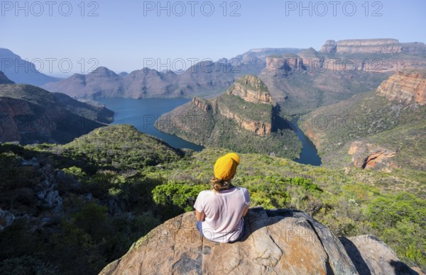 Hiker enjoying panorama, Blyde River Canyon with summit Three Rondawels, view of canyon with river