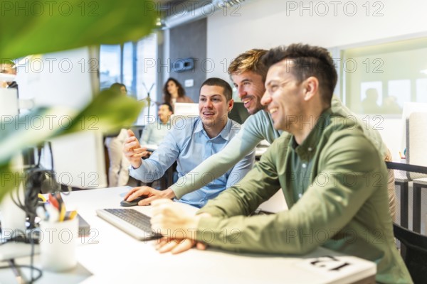 Programmers collaborating on code in a bright, modern office, showcasing teamwork and innovation in