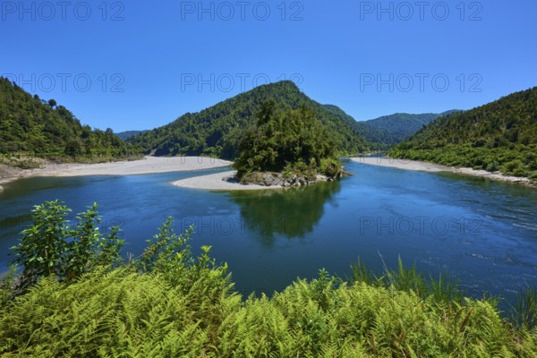 River bend with green mountains and lush vegetation under a blue sky, Kilkenny Lookout, Buller