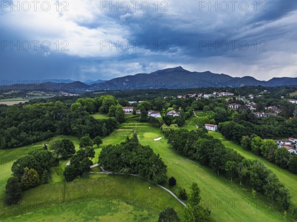 Sunset and storm clouds over Pyrenees and Saint-Jean-de-Luz from a drone, Nouvelle-Aquitaine,