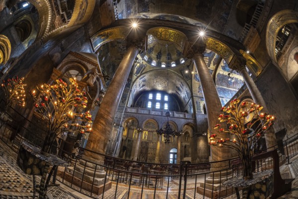 Wide angle view of the illuminated interior of saint mark's basilica in venice, italy, showcasing