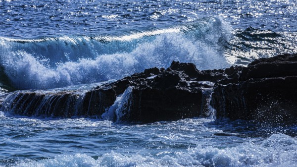 Rugged rocky coastline and foaming spray, on Stecci beach, near Capoliveri, Elba Island, Tuscan