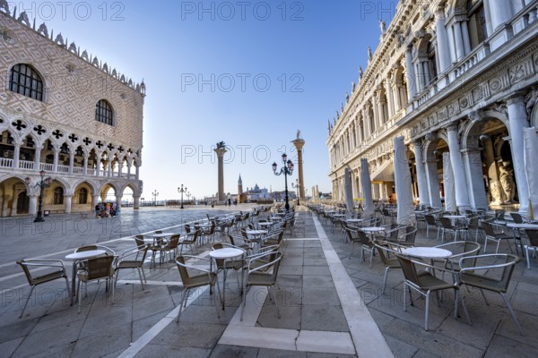 Chairs and tables of cafes at Piazetta San Marco, Doge's Palace and Colonna di San Marco and