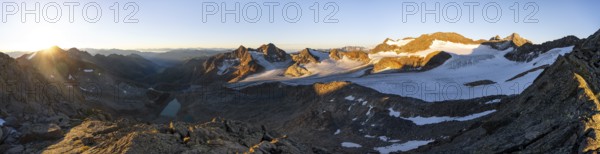 Picturesque high mountain landscape at sunrise with alpenglow, blue glacial lakes, glaciers and