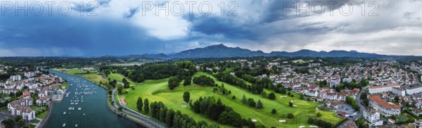 Panorama of Sunset and storm clouds over Pyrenees and Saint-Jean-de-Luz from a drone,