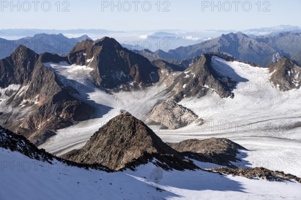 At the summit of Wilder Freiger, picturesque high mountain landscape with snow, view of