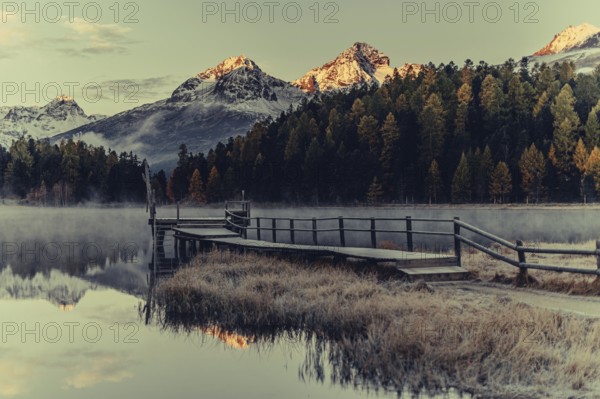 Lake Staz near Sankt Moritz in the Engadin in Switzerland. Morning atmosphere with fog in autumn.