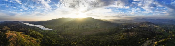 Panorama of Sunset over Mountains and Coniston Water from drone, Lake District National Park,