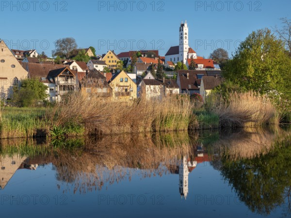 The old town centre with the Herz Jesu church is reflected in the River Wörnitz, Harburg,