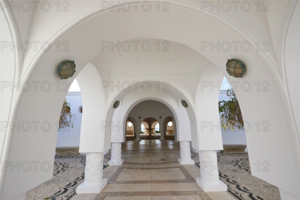 A bright corridor with white arches and decorative floor mosaic, Kalithea, Kallithea, thermal