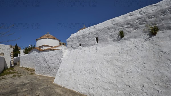 Church of Agia Kioura, White monastery wall under a blue sky, simple and traditional, Church,