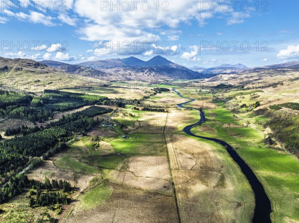Farms and Mountains over River Dochart and Road A85 from a drone, Perthshire, Scotland, UK