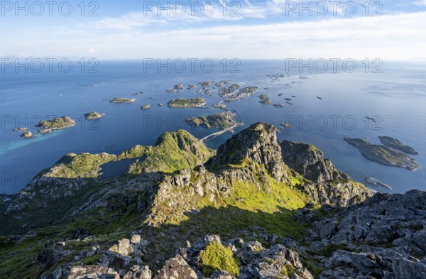 View of numerous small rocky islands with houses, at the summit of Festvågtind, view of