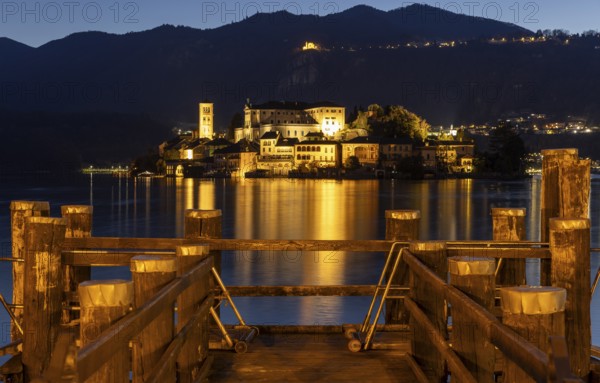 Wooden footbridge with view of Isola San Guilio, Orta San Giulio, on Lake Orta, Province of Novara,