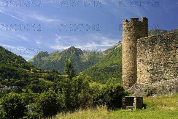 The ruins of the Château Sainte-Marie castle in Esterre and the mountain landscape near