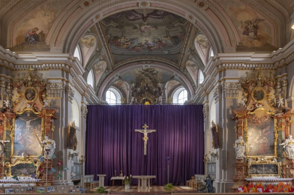Side altars and large purple Lenten cloth in front of the high altar, baroque parish church of St