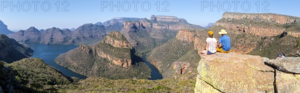 Two hikers enjoying panorama, Blyde River Canyon with Three Rondawels peak, view of gorge with